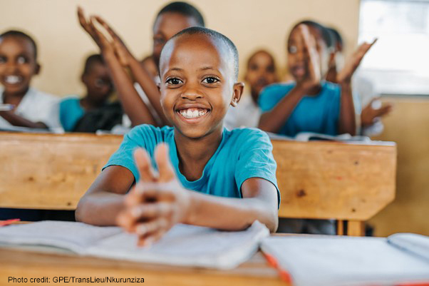 Close up of a girl clapping in class, Kamonyi, Rwanda