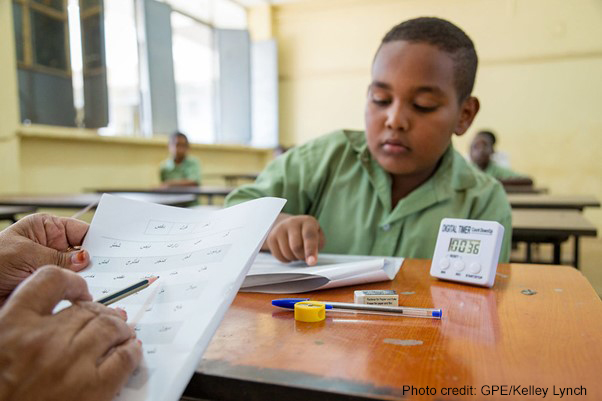 A student identifies letters during a national learning assessment, Sudan.