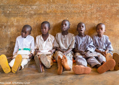 A group of boys sit on the floor leaning against the wall during a lesson at their primary school in Roni, Jigawa State, Nigeria.