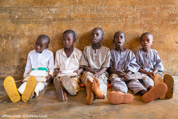 A group of boys sit on the floor leaning against the wall during a lesson at their primary school in Roni, Jigawa State, Nigeria.