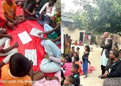 Children sit around in a circle at a learning camp observed by the project team.