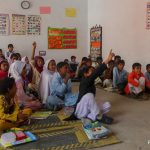 Pre-primary school students sit on mats on the floor of an early childhood education class in Punjab, Pakistan