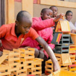Students build during an educational activity at Isare Youth Center, Burundi.