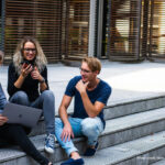 Young people sitting chatting on steps
