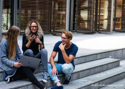Young people sitting chatting on steps
