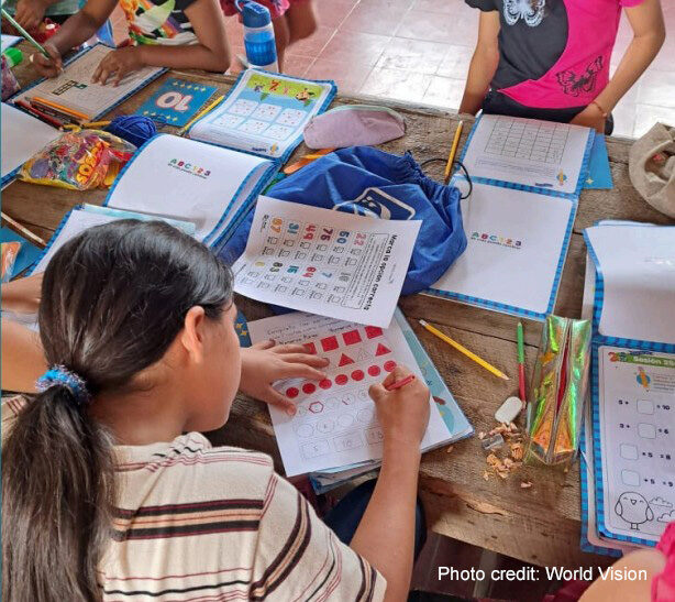 A student going through her workbook in class, Chile.