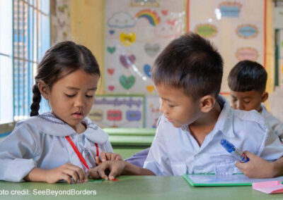 Two young children learn together in class, Cambodia