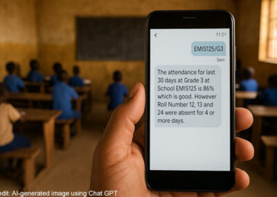 A teacher’s hand holds a mobile phone telling them about the attendance record of their class for the last 30 days.