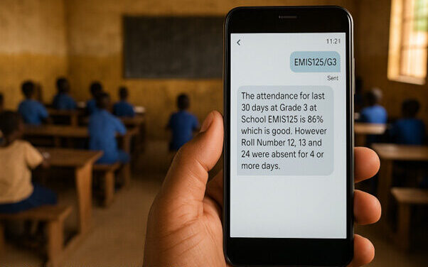 A teacher’s hand holds a mobile phone telling them about the attendance record of their class for the last 30 days.