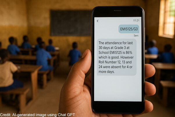 A teacher’s hand holds a mobile phone telling them about the attendance record of their class for the last 30 days.
