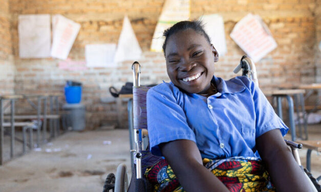 Portrait of Grace, a student, sitting in a wheelchair inside an empty classroom in her primary school in Chinsali district, Zambia.