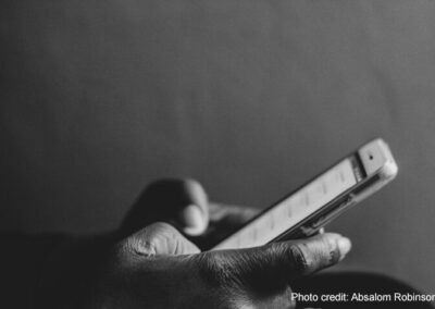 A hand using a mobile phone.