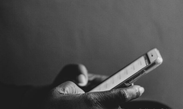 A hand using a mobile phone.