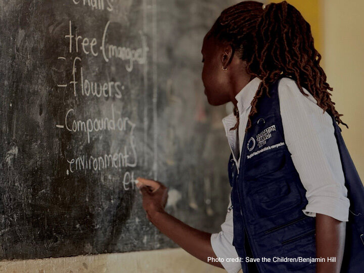 Teacher Agency Teacher writes on the blackboard in Kasonga Primary School, Kyangwali Refugee Settlement, Uganda