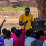 Teacher teaching under a tree in Ghana
