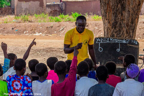 Teaching with Ubuntu Teacher teaching under a tree in Ghana