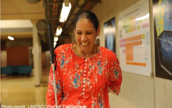 A blind teacher wearing a red top
