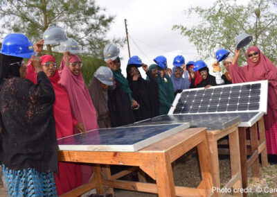 Participants in BRIDGES project with hard hats and solar panels