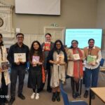 Photp of a group of people in an UKFIET Conference 2025 session holding children's books