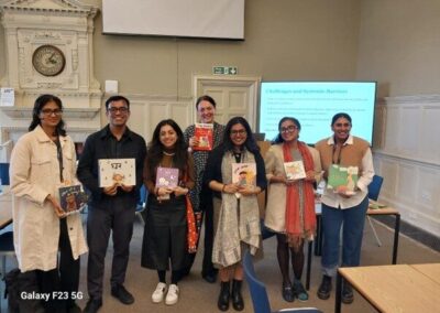 Photp of a group of people in an UKFIET Conference 2025 session holding children's books