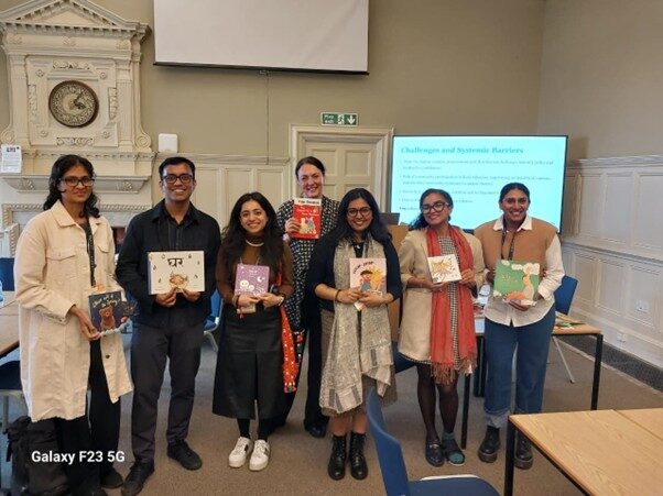 Chirldrens literature Photp of a group of people in an UKFIET Conference 2025 session holding children's books