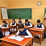 Teacher standing at the back of a class