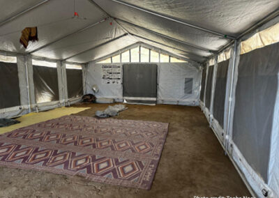A temporary learning space in Sindh province, Pakistan. A patterned rug on the floor of a tented building