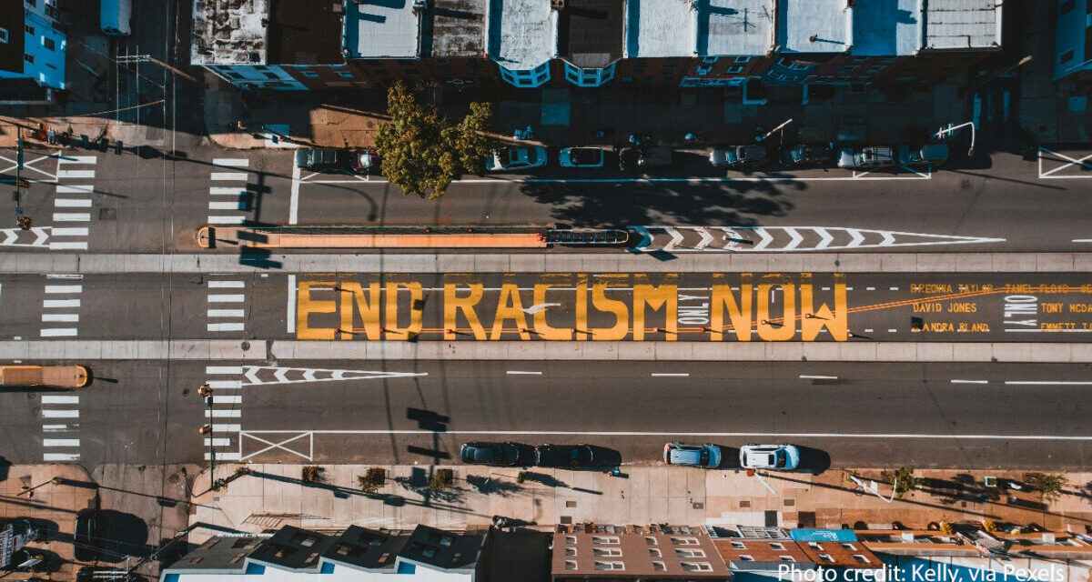 Road from above with ‘END RACISM NOW’ painted on it, Philadelphia, USA.