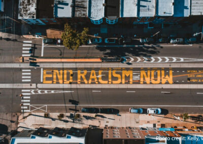 Road from above with ‘END RACISM NOW’ painted on it, Philadelphia, USA.