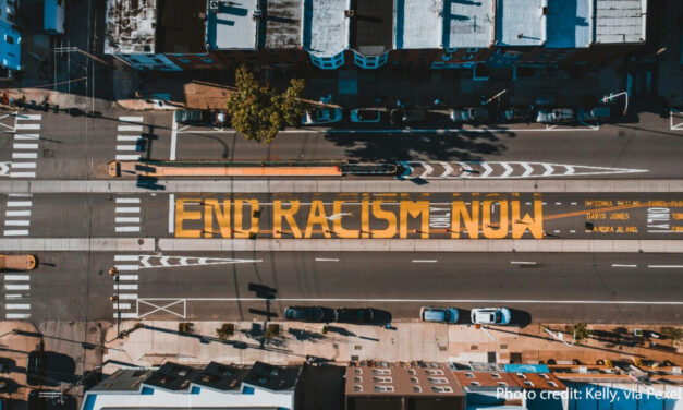 Road from above with ‘END RACISM NOW’ painted on it, Philadelphia, USA.