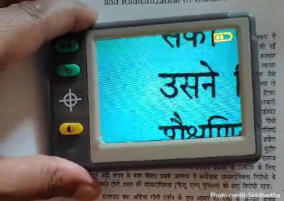 Siddartha, a male teacher with a visual disability , uses a visual aid.