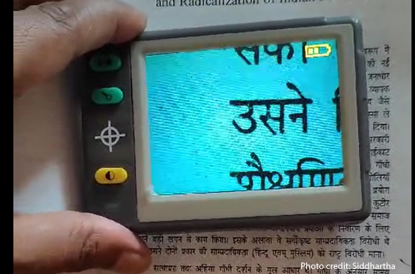 Teaching against the odds Siddartha, a male teacher with a visual disability , uses a visual aid.