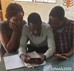 Three teachers looking at a mobile device