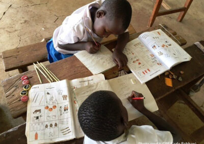 Two students do maths work together in class, Nairobi, Kenya.
