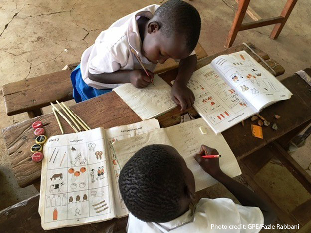 Two students do maths work together in class, Nairobi, Kenya.