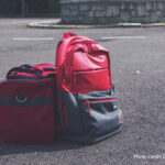 Two bags on the floor next to each other.