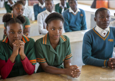 Students sit at desks in class, Zambia.