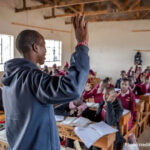 A teacher and his students in maths class, Kenya