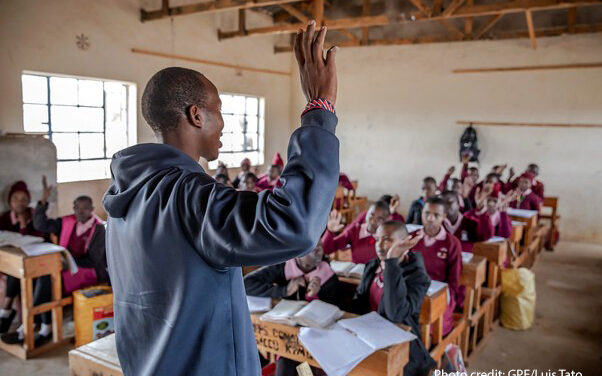 A teacher and his students in maths class, Kenya