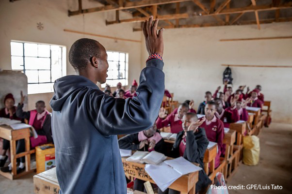 A teacher and his students in maths class, Kenya