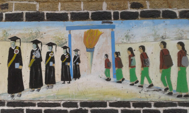Painting on a school wall of students walking into a school and coming out as accomplished graduates.