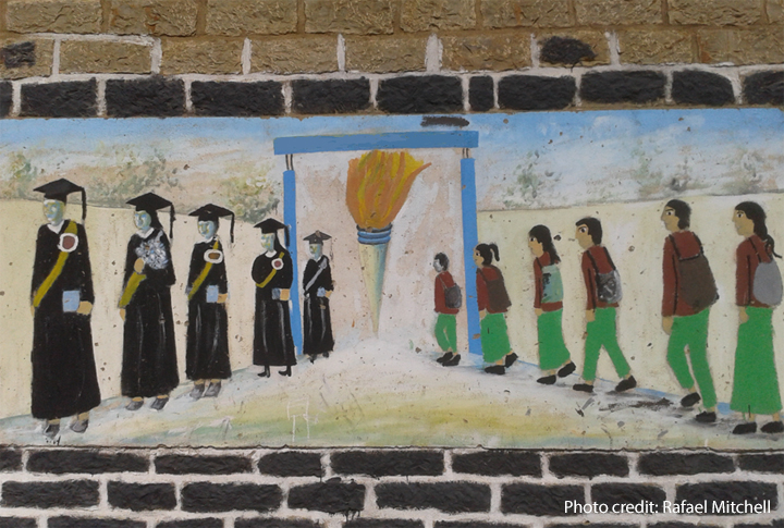 Restoring the right to Education Painting on a school wall of students walking into a school and coming out as accomplished graduates.