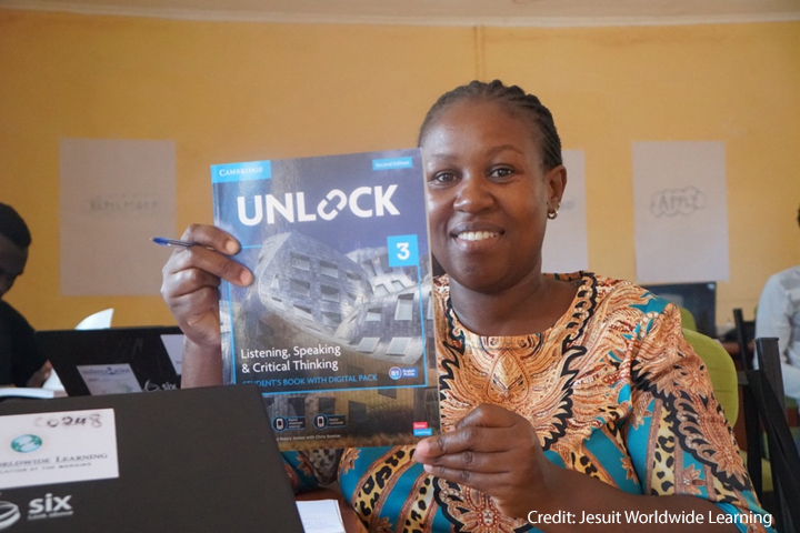 Transforming English Language A GEL facilitator at a learning centre at Kakuma Refugee Camp in Kenya holding a Cambridge coursebook