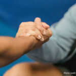 Two hands grasping each other in support
