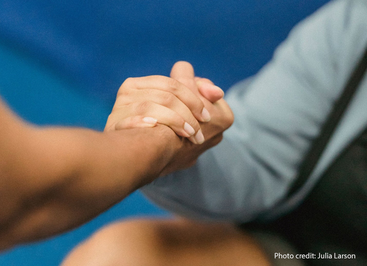 Two hands grasping each other in support