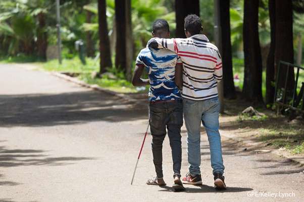 Beyond Access Two men walking together - Peer support from a fellow student for a visually impaired student, Oromia, Ethiopia