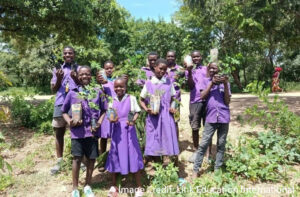 Children plant trees during Disaster Risk Management Club, Malawi.