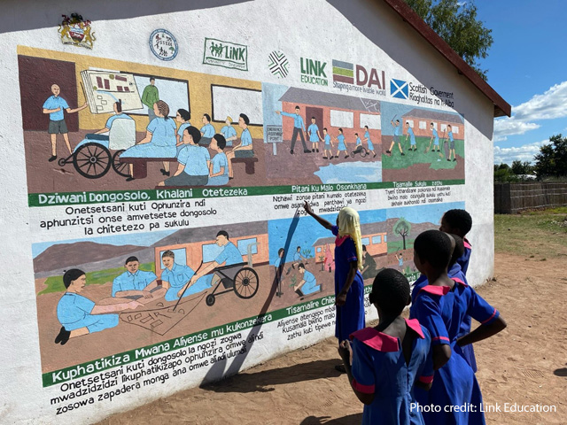 Children look at a school mural, Malawi