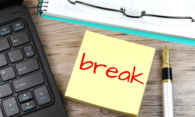 Post it note with "break" written on it in red. with keyboard and pen alongside