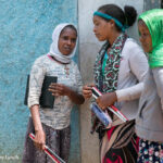 Visually impaired students chat outside class with their folding sticks in their hands, Oromia, Ethiopia